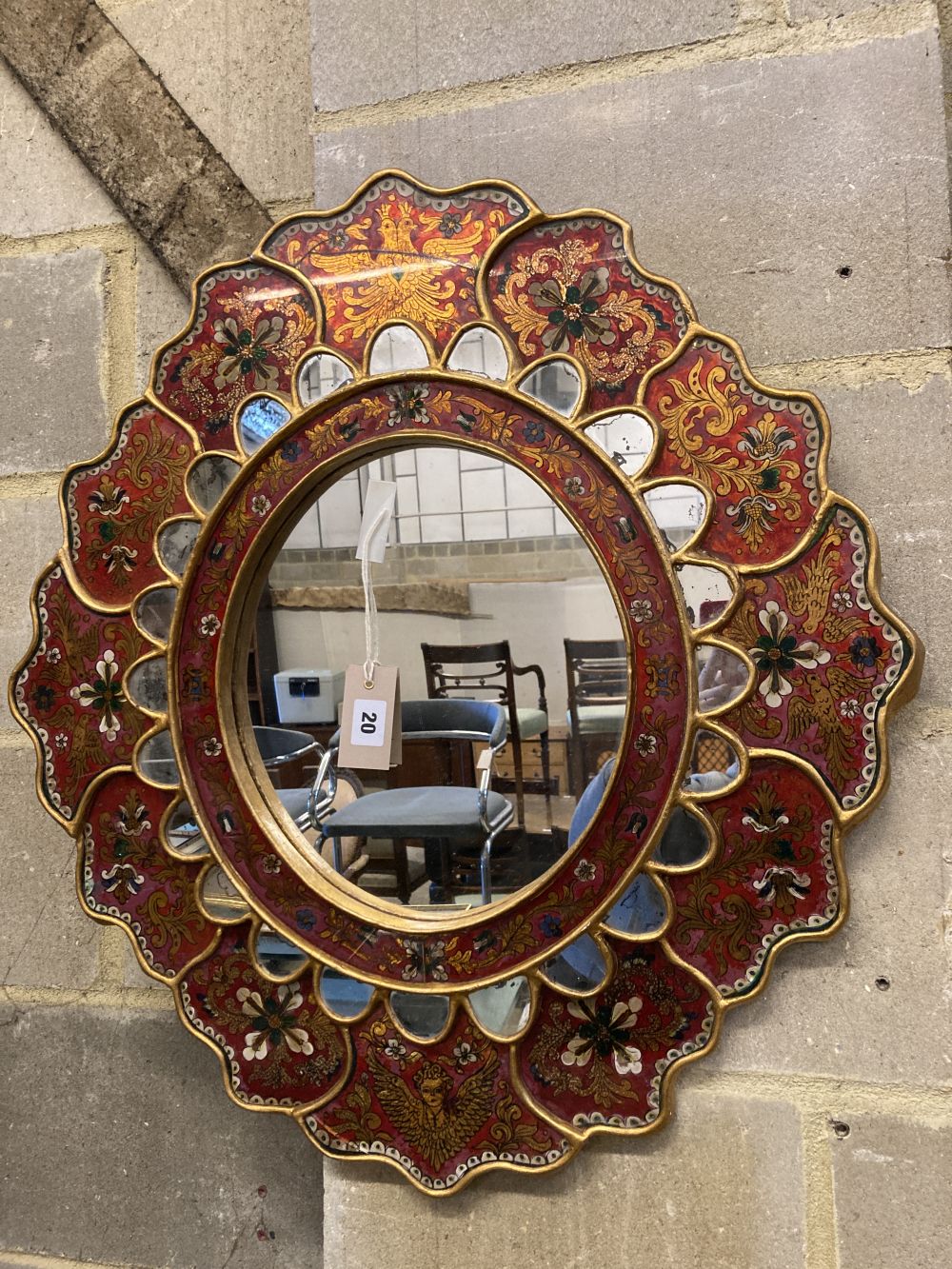 An Indian oval painted wall mirror, width 63cm, height 69cm